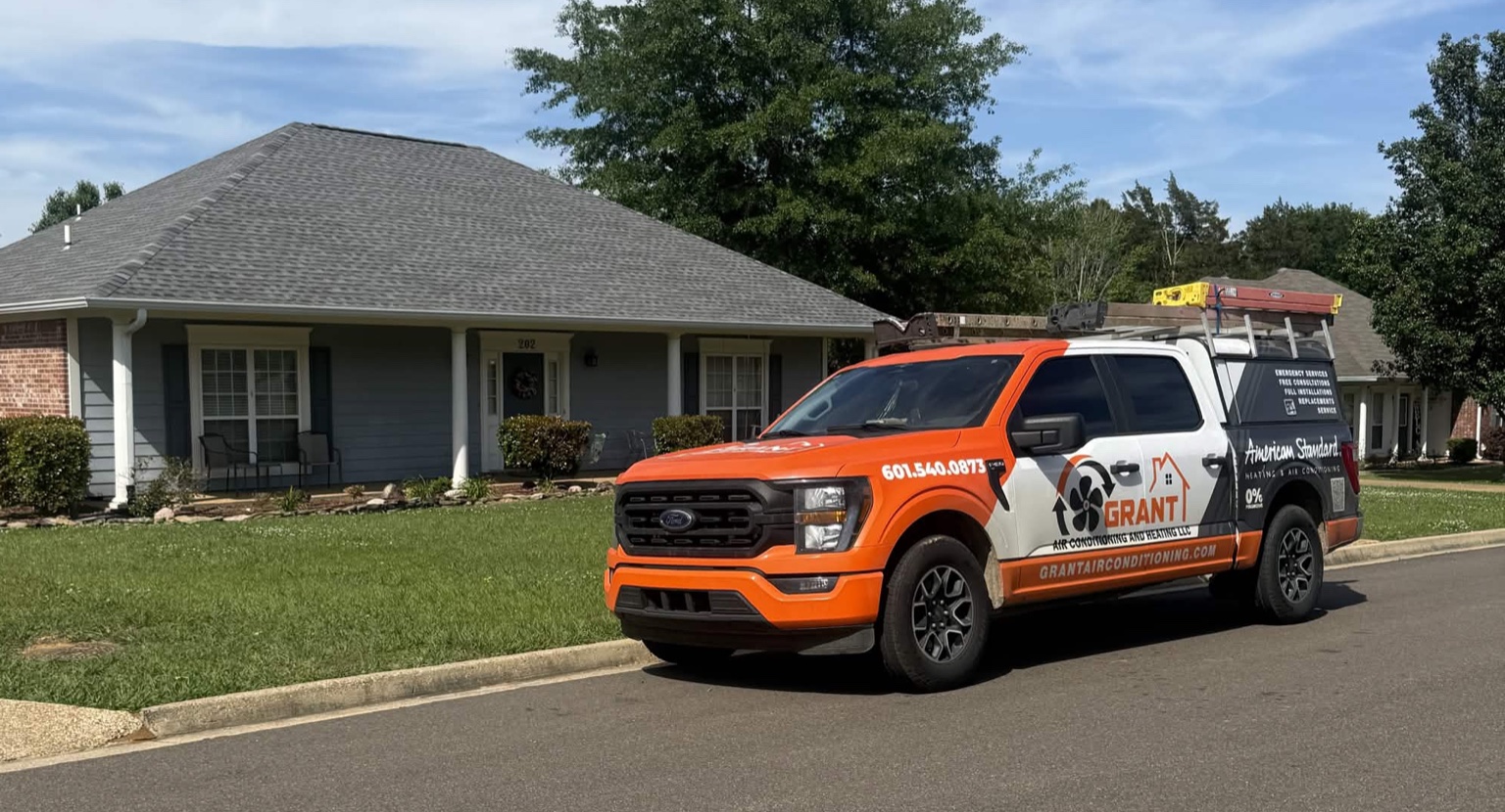 Grant A/C & Heating service truck parked outside a Mississippi home