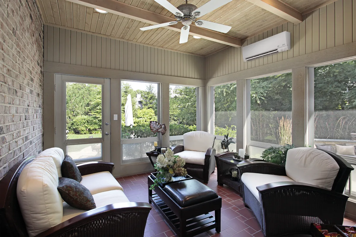 Comfortable living room with large windows and a ceiling fan