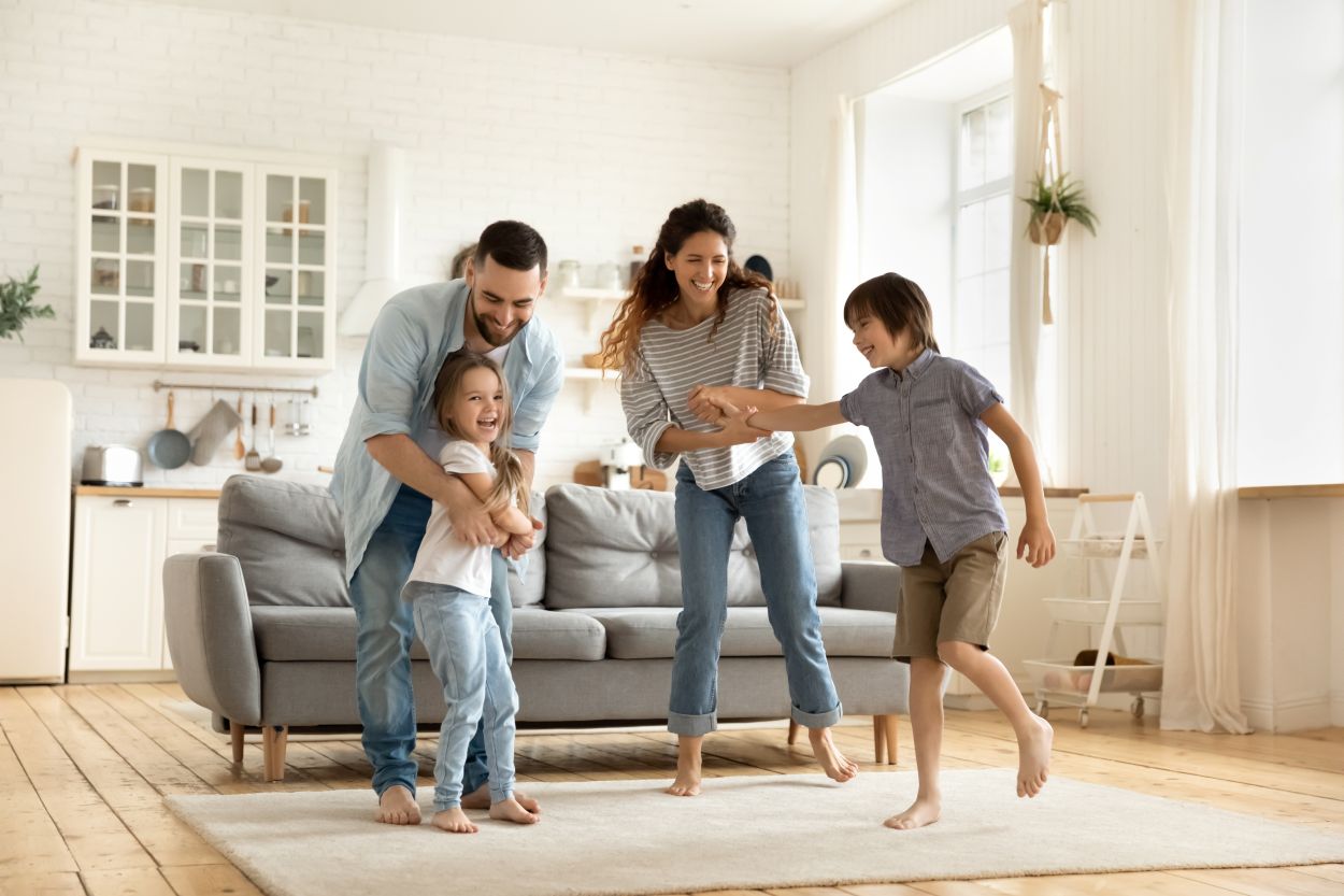 Family moving into a new home with boxes in the living room