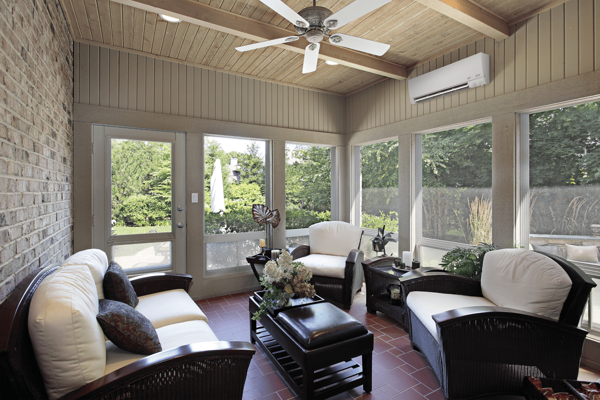 Comfortable living room with large windows and a ceiling fan